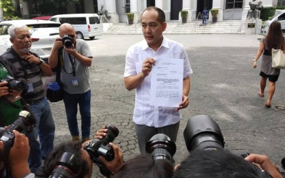 <p><strong>'OUTING' PROBE. </strong>Lawyer Vic Rodriguez, spokesperson of former Senator Ferdinand 'Bongbong' Marcos Jr., presents a copy of their petition asking the Presidential Electoral Tribunal (PET) to probe the recent swimming party of some PET staff which was joined by a revisor of Vice President Leni Robredo at the Supreme Court in Manila on Monday (July 9, 2018). <em>(PNA photo by Christopher Lloyd Caliwan)</em></p>